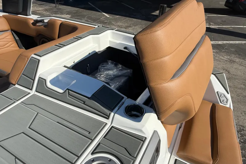 Slide: The Image of 2026 Supra SA 550 boat interior with tan leather seats and storage compartment. - 9