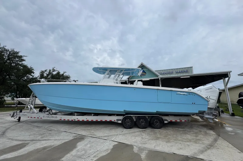 The Image of 2025 Invincible 40 Catamaran in light blue on a trailer, parked outdoors. - 1