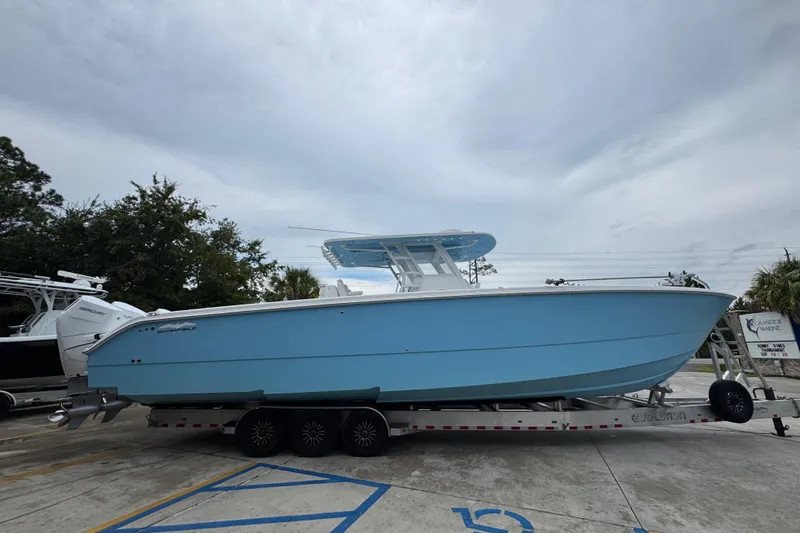 Slide: The Image of 2025 Invincible 40 Catamaran in light blue on trailer, parked outdoors. - 12
