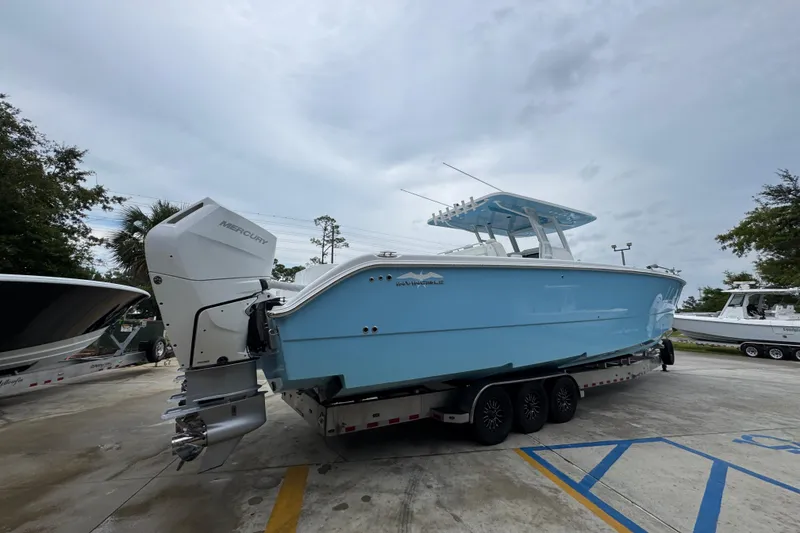 Slide: The Image of 2025 Invincible 40 Catamaran in light blue on a trailer, featuring Mercury outboard engines. - 14