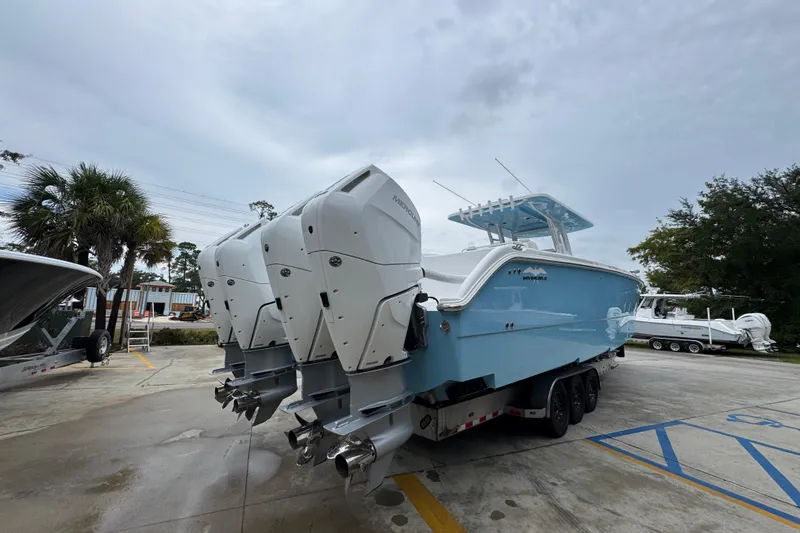 Slide: The Image of 2025 Invincible 40 Catamaran with triple outboard engines on a trailer. - 15