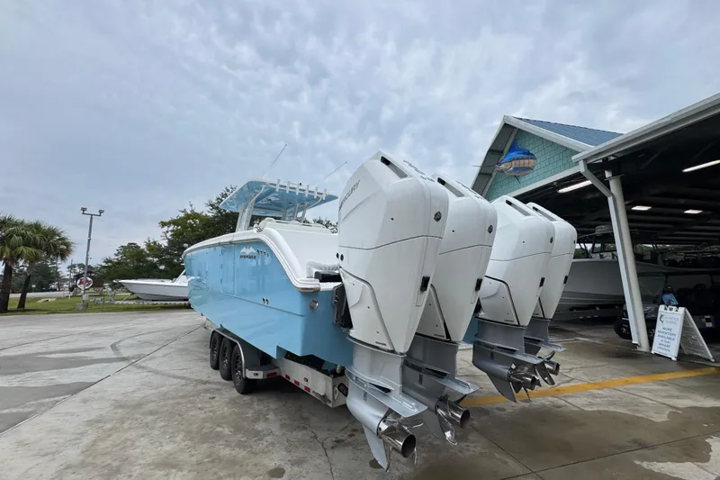 Slide: The Image of 2025 Invincible 40 Catamaran with triple outboard engines on a trailer. - 18