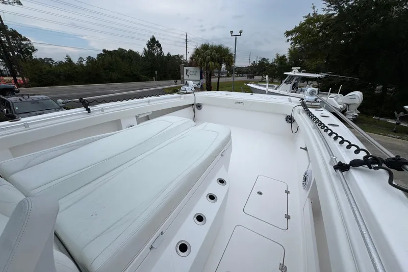 Slide: The Image of 2025 Invincible 40 Catamaran with spacious deck and seating, docked outdoors. - 22