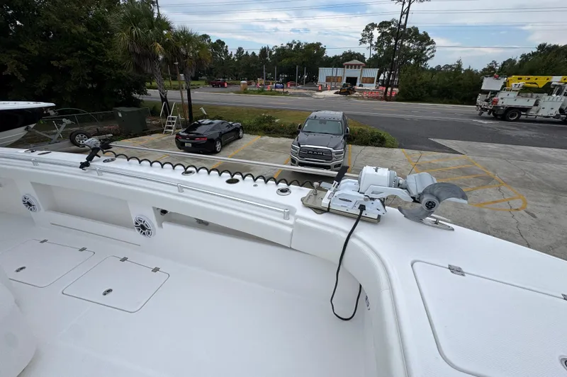 Slide: The Image of 2025 Invincible 40 Catamaran deck with fishing equipment and parking lot view. - 24