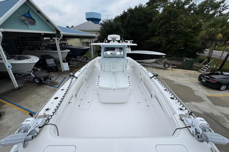 Slide: The Image of 2025 Invincible 40 Catamaran docked at a marina, showcasing spacious deck and modern design. - 26