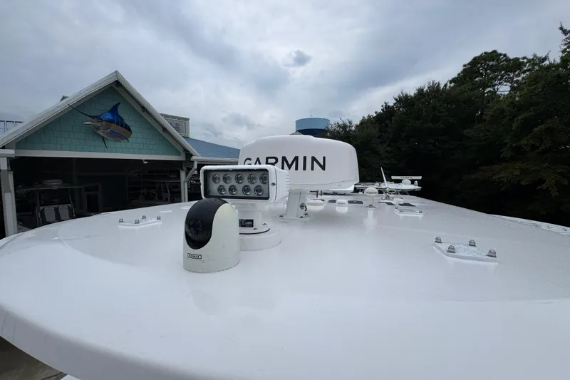 Slide: The Image of Rooftop of 2025 Invincible 40 Catamaran with Garmin equipment, near a building with fish decor. - 28