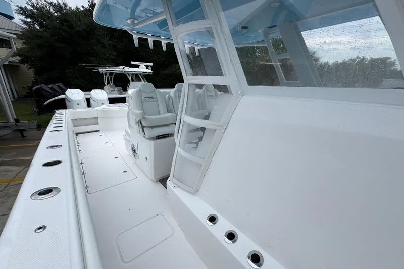 Slide: The Image of 2025 Invincible 40 Catamaran with sleek white deck and modern seating. - 30