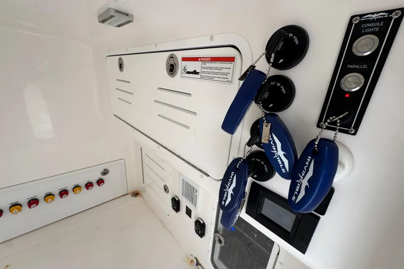 Slide: The Image of Control panel of 2025 Invincible 40 Catamaran with switches and key fobs. - 31