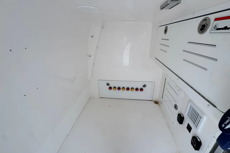 Slide: The Image of Interior view of 2025 Invincible 40 Catamaran's control panel and storage compartments. - 32