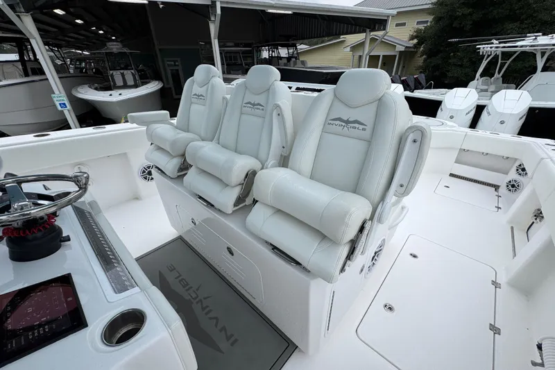 Slide: The Image of 2025 Invincible 40 Catamaran interior with luxurious seating and modern helm controls. - 33