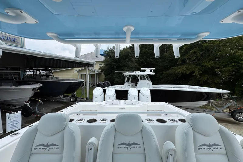 Slide: The Image of 2025 Invincible 40 Catamaran with sleek design, docked at a marina. - 35