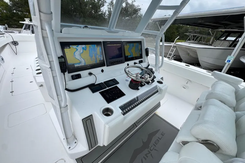 Slide: The Image of 2025 Invincible 40 Catamaran helm with dual navigation screens and modern controls. - 36
