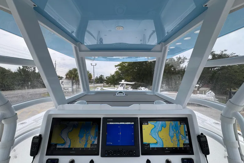 Slide: The Image of 2025 Invincible 40 Catamaran cockpit with navigation screens and panoramic view. - 38