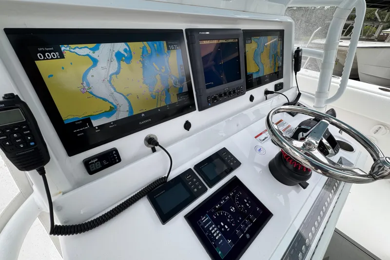 Slide: The Image of Cockpit of 2025 Invincible 40 Catamaran with advanced navigation displays and controls. - 40