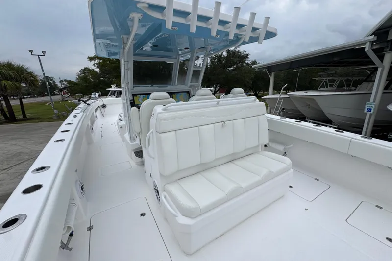 Slide: The Image of 2025 Invincible 40 Catamaran with white seating and spacious deck, docked outdoors. - 43