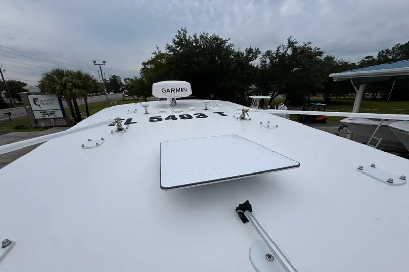 Slide: The Image of 2025 Invincible 40 Catamaran deck with Garmin equipment, overcast sky, and marina background. - 45