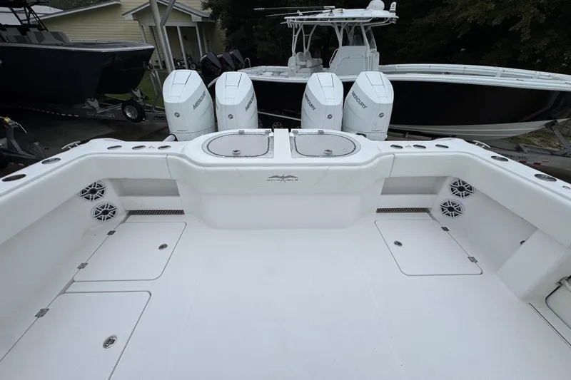 Slide: The Image of 2025 Invincible 40 Catamaran with Mercury engines, spacious deck, and modern design. - 48