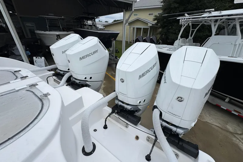 Slide: The Image of 2025 Invincible 40 Catamaran with four Mercury outboard engines in a marina setting. - 50