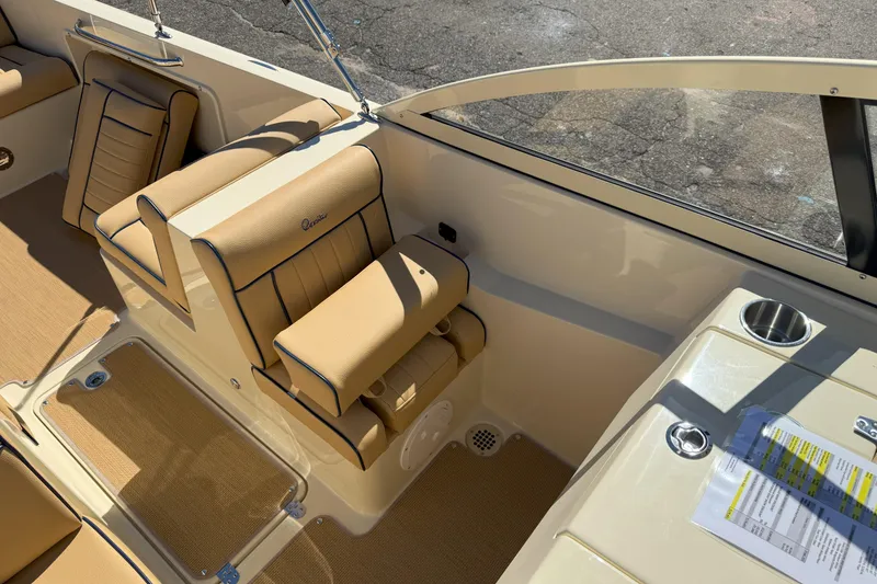 Slide: The Image of 2026 Rossiter 23 Open Bow interior with tan seating and cup holder. - 10