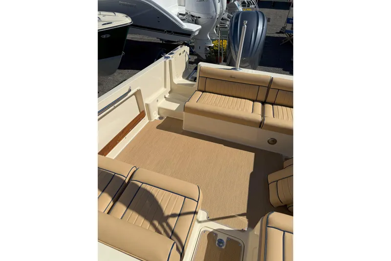 Slide: The Image of 2026 Rossiter 23 Open Bow boat interior with tan seating and spacious layout. - 12