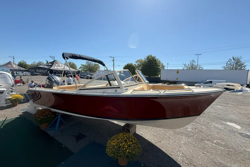 Slide: The Image of 2026 Rossiter 23 Open Bow boat displayed outdoors under clear sky. - 13