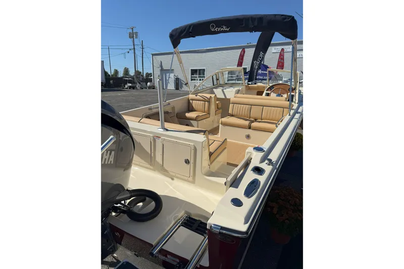 Slide: The Image of 2026 Rossiter 23 Open Bow boat with tan seating and Yamaha engine. - 4