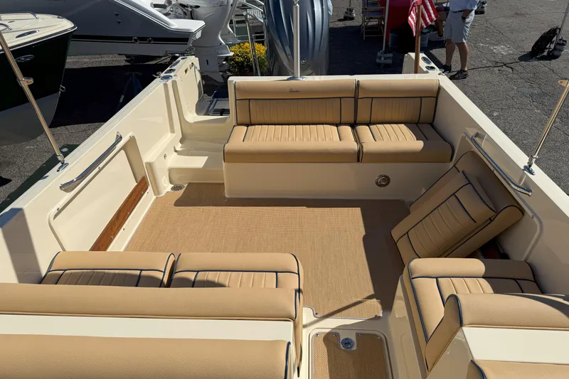Slide: The Image of 2026 Rossiter 23 Open Bow boat interior with beige seating and spacious layout. - 8
