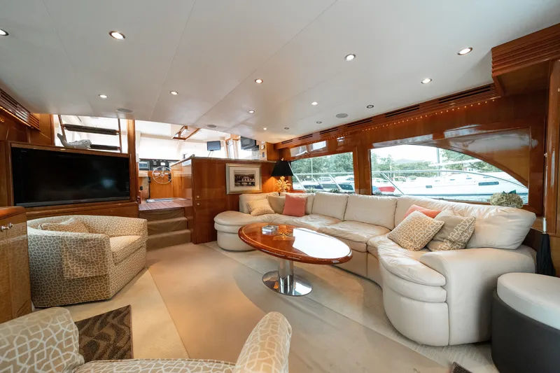 Slide: The Image of Luxurious salon of a 2008 Hatteras 64 Motor Yacht with elegant furnishings and large windows. - 46