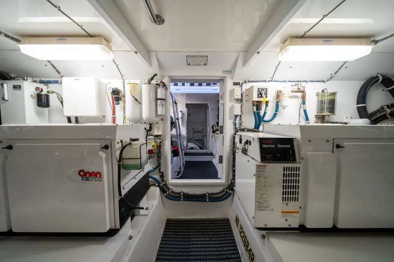 Slide: The Image of The engine room of a 2008 Hatteras 64 Motor Yacht features generators and technical equipment. - 11