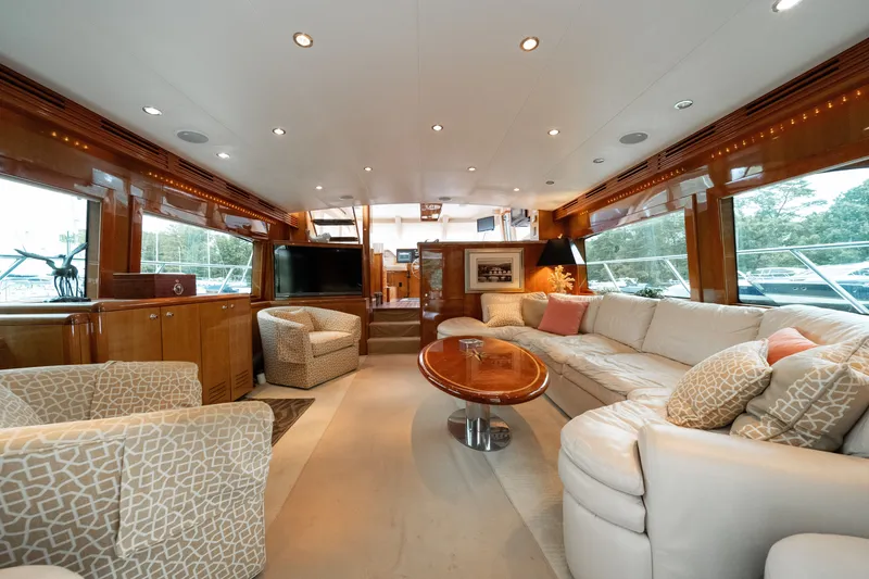Slide: The Image of Luxurious salon of a 2008 Hatteras 64 Motor Yacht with elegant furnishings and large windows. - 45