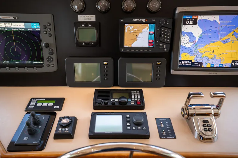 Slide: The Image of The image shows the helm of a 2008 Hatteras 64 Motor Yacht with various navigation instruments. - 31