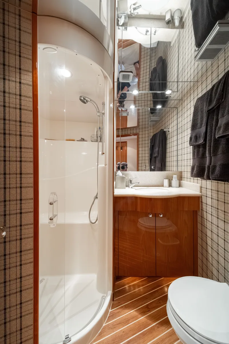 Slide: The Image of Bathroom on a 2008 Hatteras 64 Motor Yacht with shower, sink, and toilet. - 15