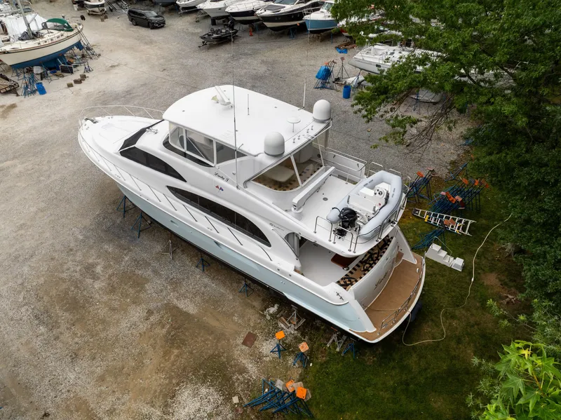 Slide: The Image of A 2008 Hatteras 64 Motor Yacht is on a dry dock, surrounded by other boats. - 5