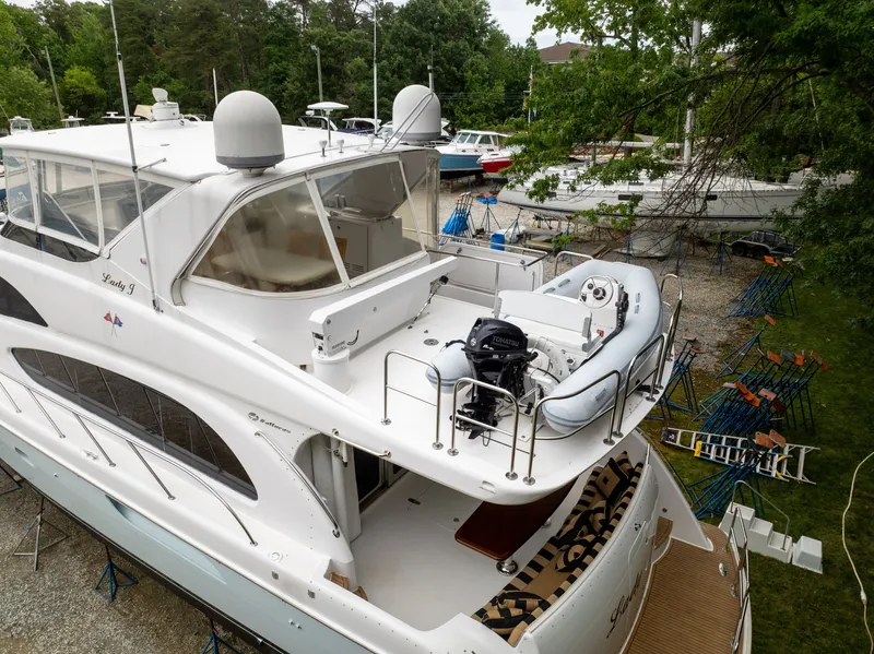 Slide: The Image of A luxurious 2008 Hatteras 64 Motor Yacht with a spacious deck and dinghy on the upper deck. - 6