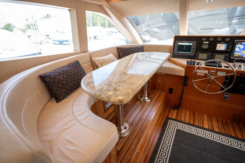 Slide: The Image of Interior of a luxury yacht with curved leather sofa, marble table, and modern helm console. - 33