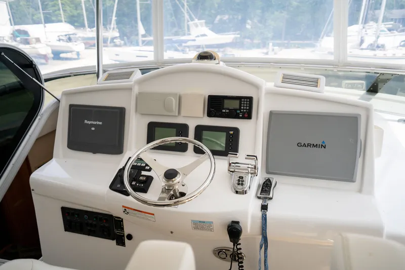 Slide: The Image of The cockpit of a 2008 Hatteras 64 Motor Yacht with modern navigation systems and controls. - 43