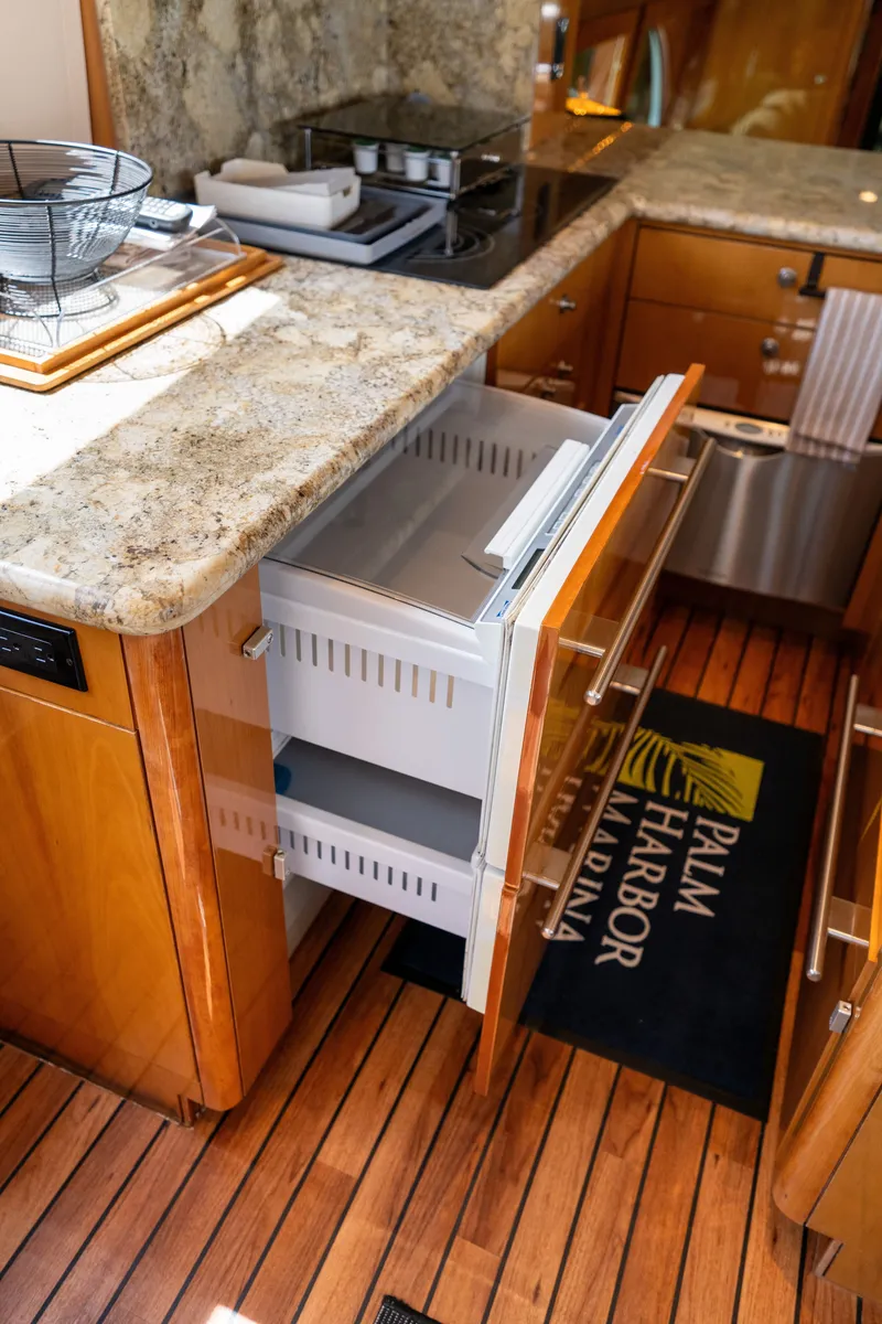 Slide: The Image of The 2008 Hatteras 64 Motor Yacht kitchen features an open drawer and a countertop. - 36