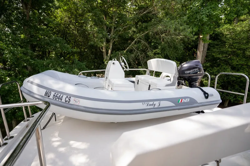 Slide: The Image of A small tender with a Tohatsu engine is secured on the deck of a yacht. - 41