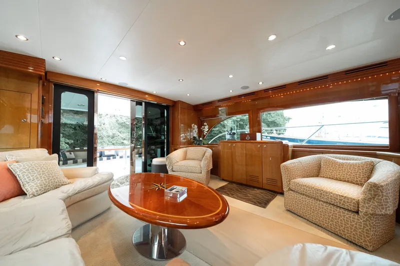 Slide: The Image of Luxurious salon of a 2008 Hatteras 64 Motor Yacht with elegant furnishings and large windows. - 47