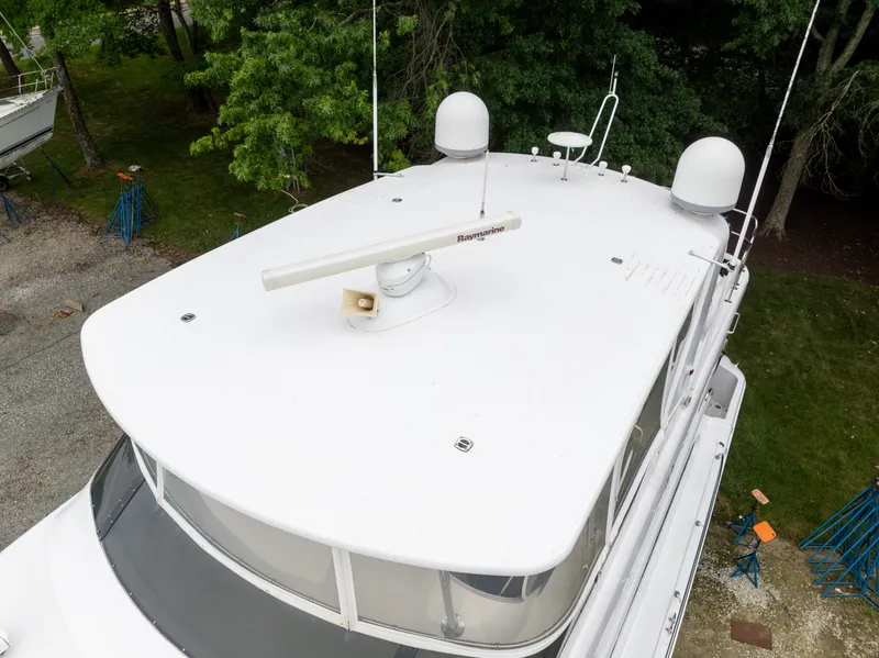 Slide: The Image of The image shows the roof of a 2008 Hatteras 64 Motor Yacht with radar equipment. - 4