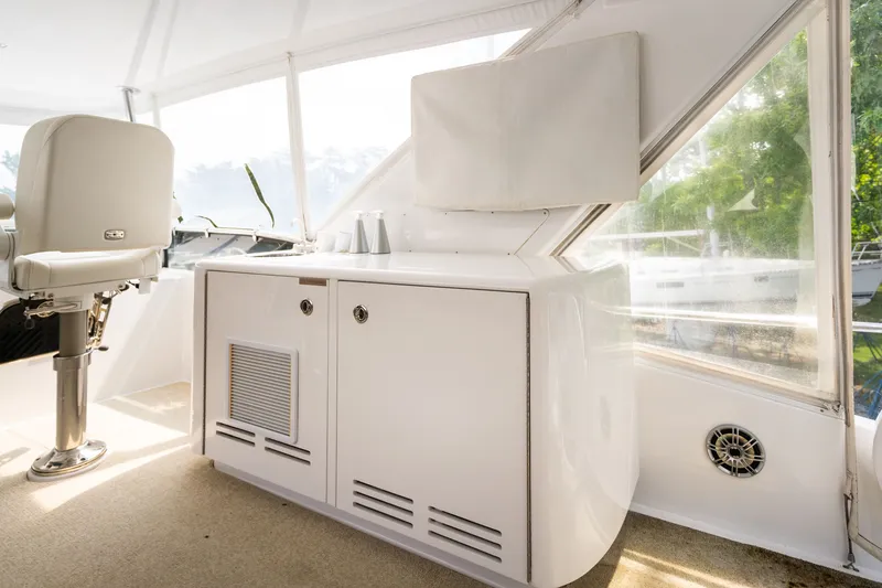 Slide: The Image of The 2008 Hatteras 64 Motor Yacht features an elegant interior with white cabinetry and a seating area. - 42