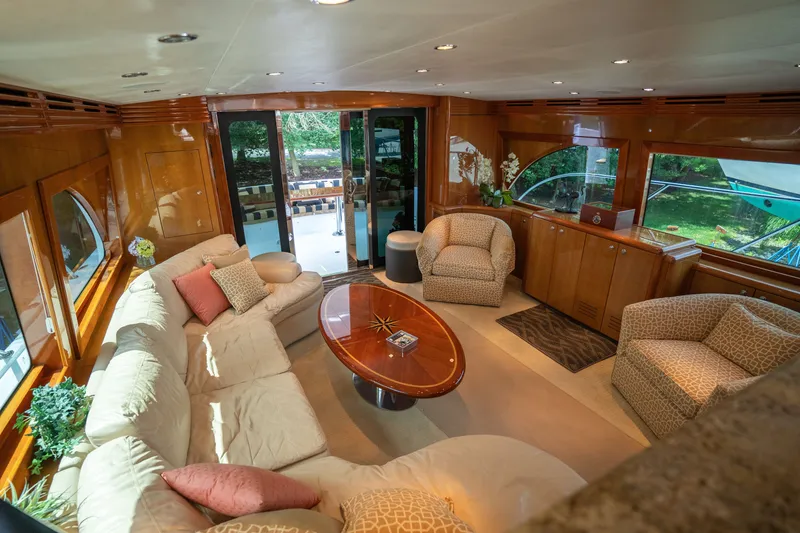 Slide: The Image of The interior of a 2008 Hatteras 64 Motor Yacht features an elegant living area with comfortable sofas and armchairs. - 39