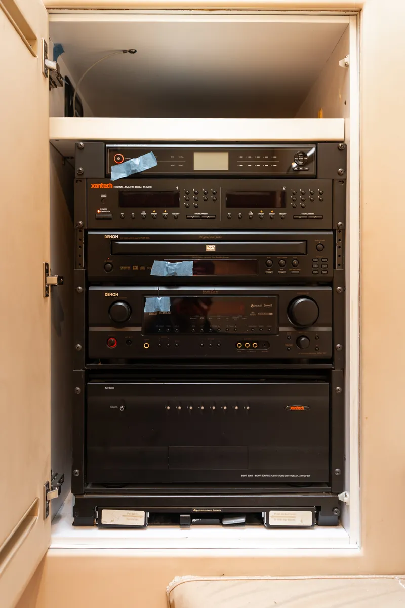 Slide: The Image of A cabinet with various electronic devices, including an amplifier and audio receiver. - 24
