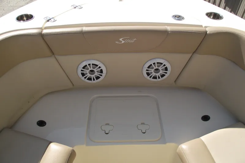 Slide: The Image of 2022 Scout 215 Dorado boat interior with beige seating and built-in speakers. - 10