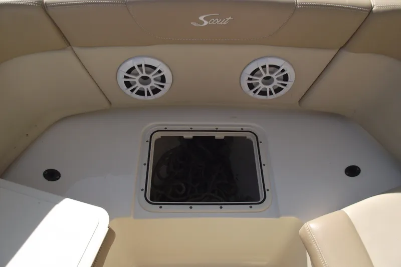Slide: The Image of 2022 Scout 215 Dorado boat interior with speakers and storage compartment. - 11