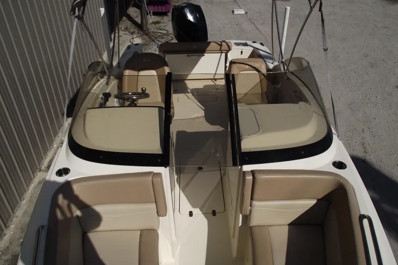 Slide: The Image of 2022 Scout 215 Dorado boat interior with beige seating and steering wheel. - 12