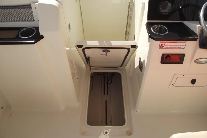 Slide: The Image of 2022 Scout 215 Dorado boat interior with open storage compartment. - 14