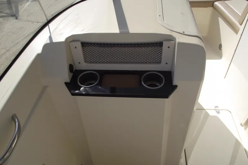Slide: The Image of 2022 Scout 215 Dorado boat interior with cup holders and storage compartment. - 16