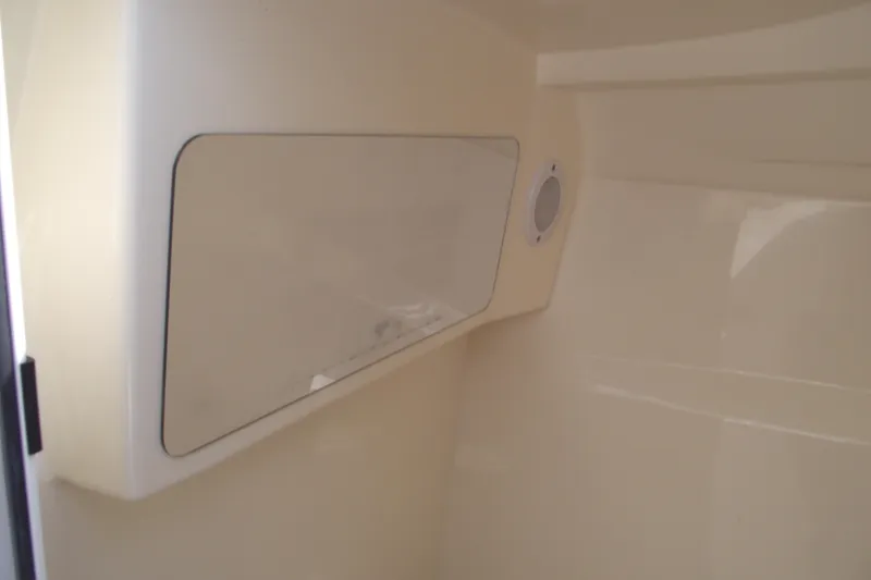 Slide: The Image of 2022 Scout 215 Dorado interior cabin with storage compartment and speaker. - 19