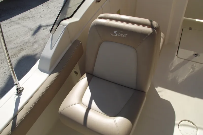 Slide: The Image of 2022 Scout 215 Dorado boat seat with logo, beige upholstery, and sleek design. - 22